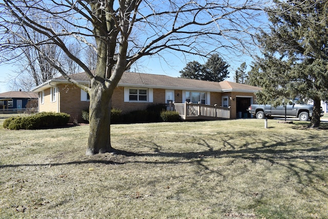 single story home with a front lawn, brick siding, and an attached garage