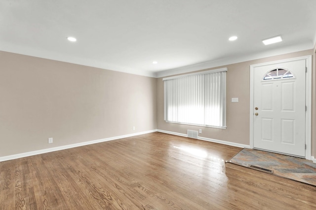 foyer entrance with recessed lighting, visible vents, baseboards, and wood finished floors