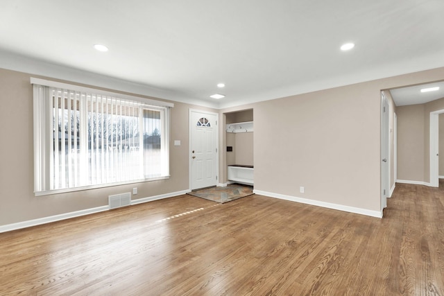 foyer entrance with recessed lighting, wood finished floors, visible vents, and baseboards