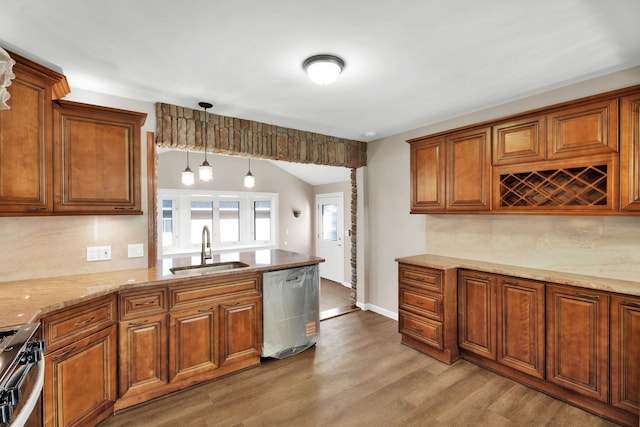 kitchen with a sink, appliances with stainless steel finishes, and brown cabinetry