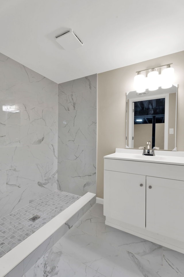 full bath featuring a marble finish shower, marble finish floor, and vanity