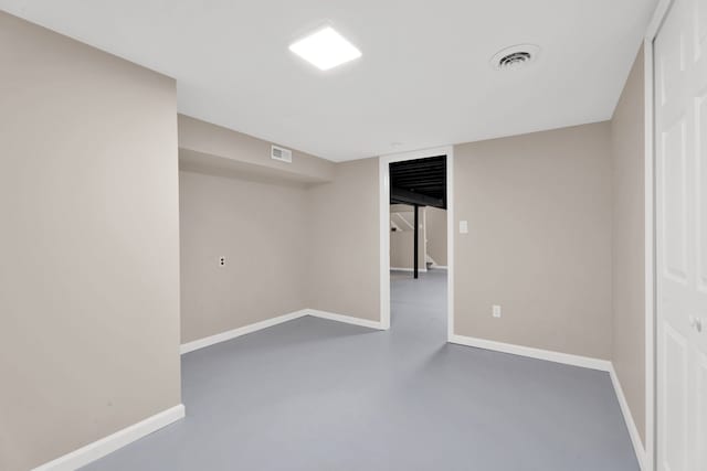 finished basement featuring visible vents and baseboards