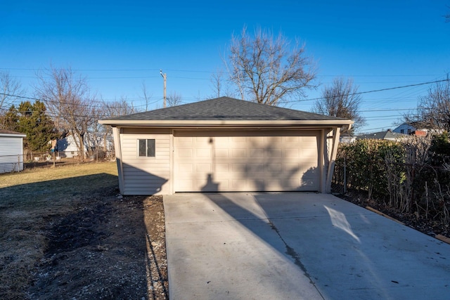 detached garage featuring fence