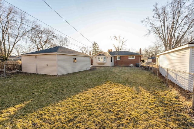 view of yard featuring an outdoor structure and fence