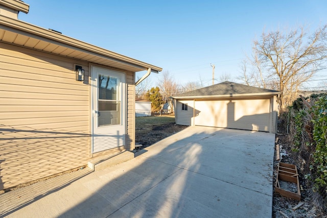 view of home's exterior featuring an outbuilding, a garage, and fence