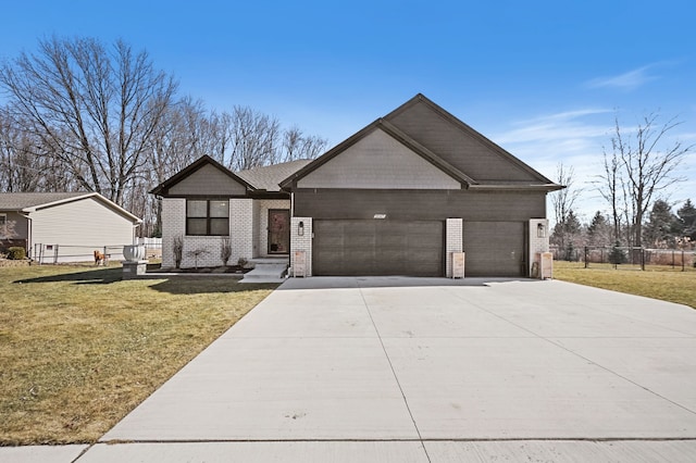 view of front of house featuring fence, concrete driveway, an attached garage, a front yard, and brick siding