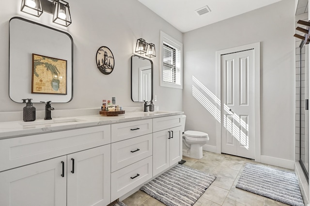 full bath featuring double vanity, toilet, baseboards, and a sink