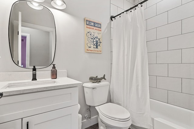 bathroom featuring vanity, toilet, and shower / bath combo with shower curtain