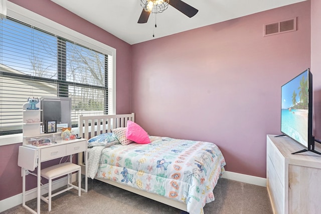 carpeted bedroom featuring visible vents, a ceiling fan, and baseboards