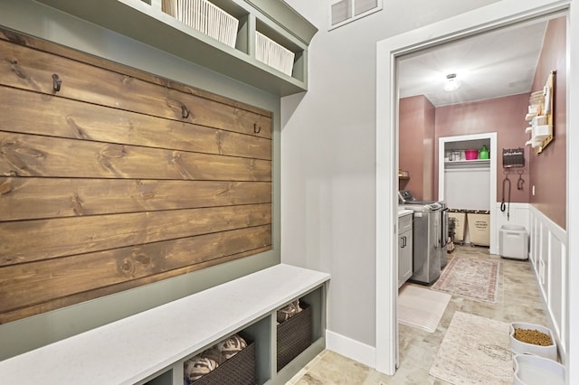 mudroom with visible vents and washer and dryer