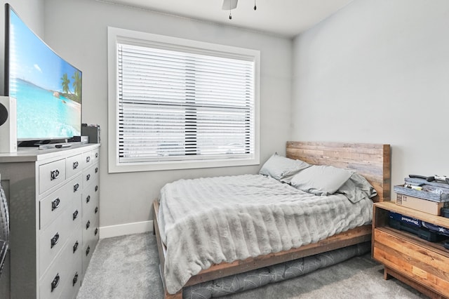 carpeted bedroom with a ceiling fan and baseboards