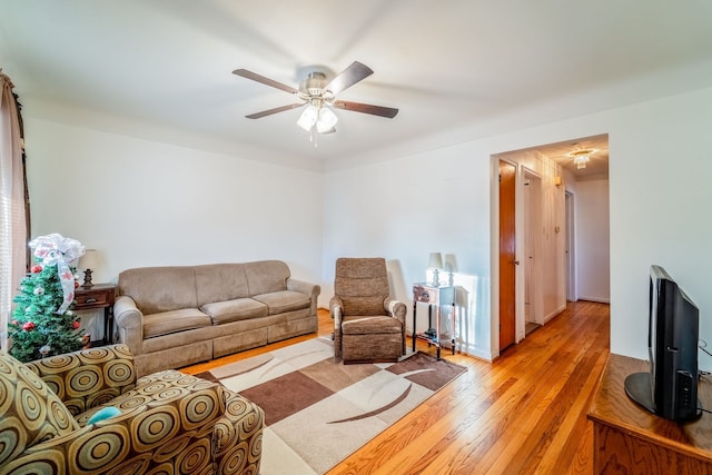 living room featuring light wood-type flooring and ceiling fan