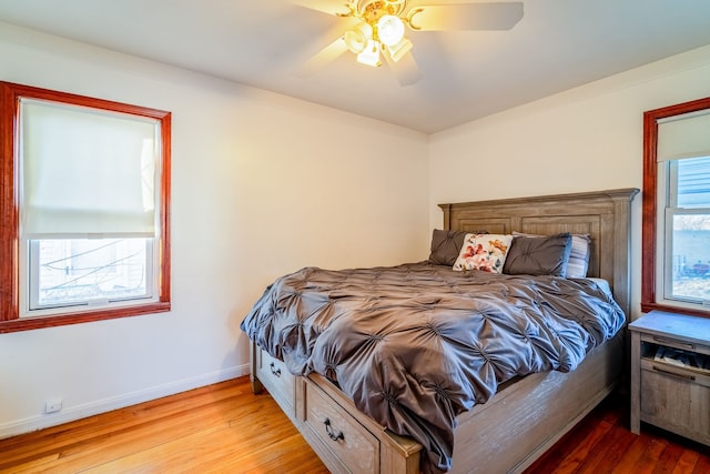 bedroom featuring wood finished floors, baseboards, and ceiling fan