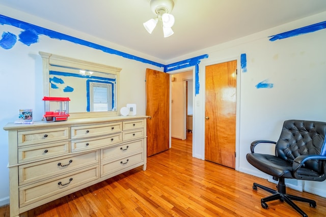 living area with baseboards and light wood finished floors