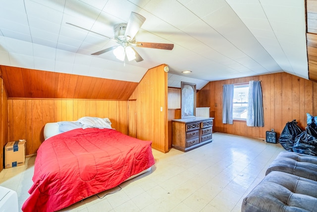 bedroom with lofted ceiling, a ceiling fan, light floors, and wood walls