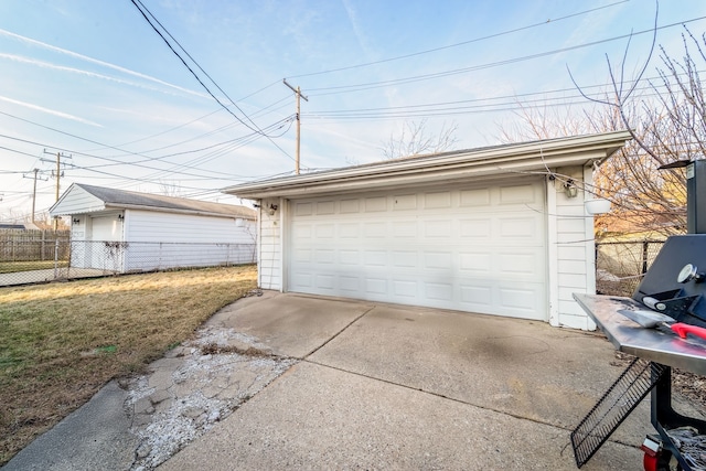 detached garage featuring fence