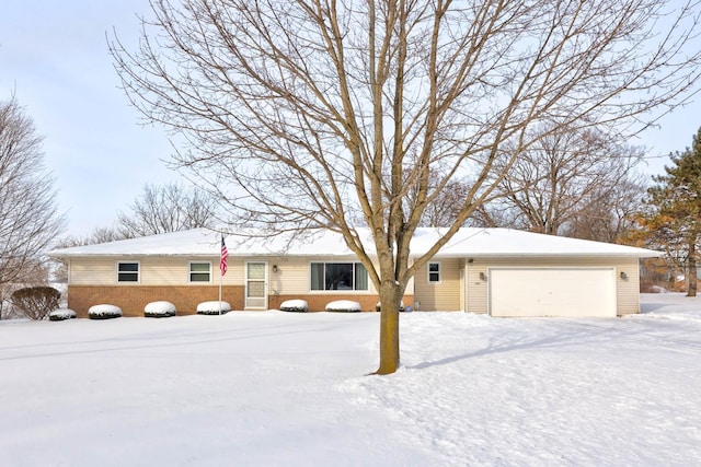 ranch-style home featuring brick siding and an attached garage