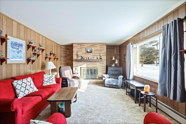 living area with carpet floors, wood walls, baseboard heating, and a fireplace