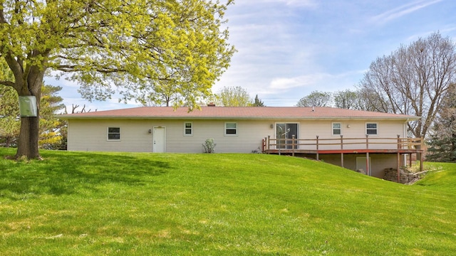 back of house with a lawn and a wooden deck