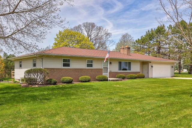 ranch-style house with an attached garage, a front lawn, brick siding, a chimney, and metal roof