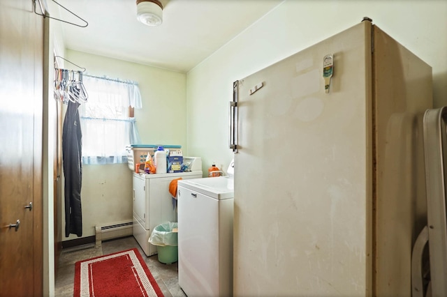 washroom featuring laundry area, a baseboard heating unit, and washing machine and dryer