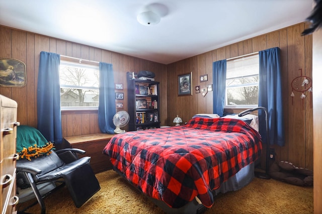 carpeted bedroom with wood walls