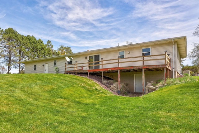 rear view of property with a yard and a deck