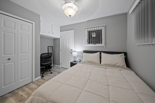 bedroom with light wood-type flooring and a closet