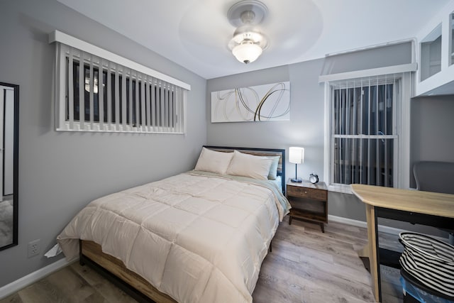 bedroom with baseboards and wood finished floors