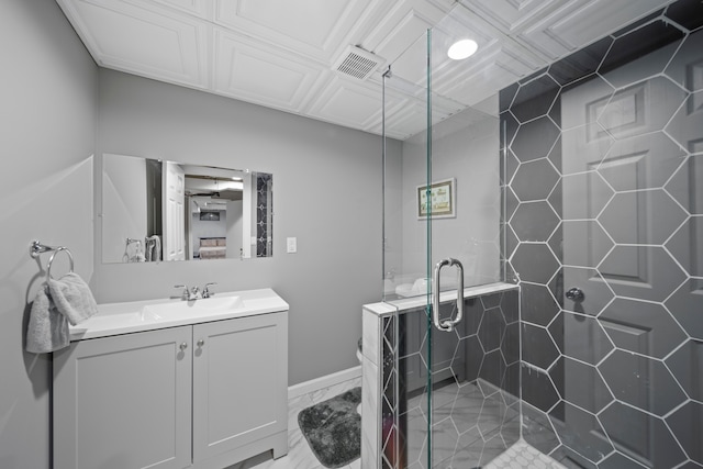 bathroom with vanity, baseboards, visible vents, and a stall shower