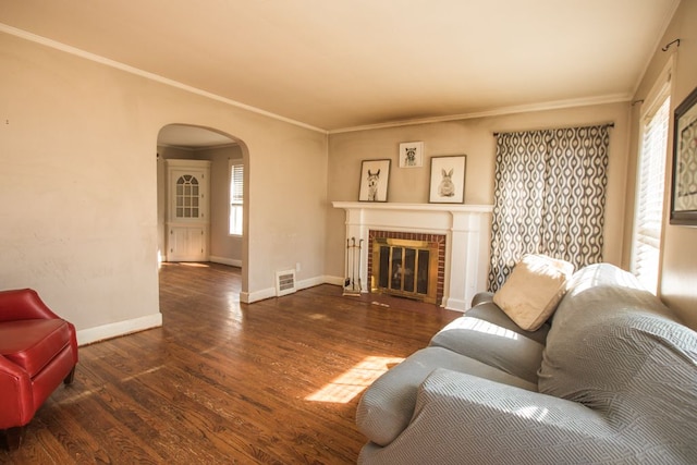 living room with a wealth of natural light, baseboards, arched walkways, and wood finished floors