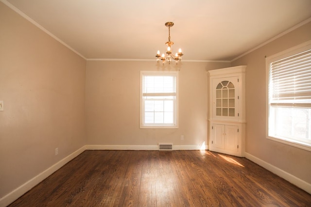 empty room featuring visible vents, baseboards, a chandelier, ornamental molding, and dark wood-style flooring