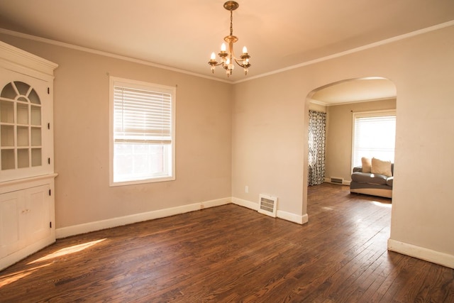 unfurnished room featuring visible vents, dark wood-style floors, arched walkways, crown molding, and baseboards