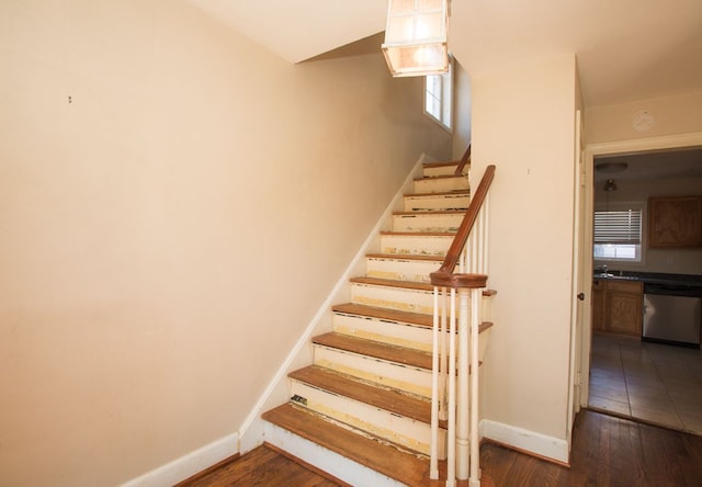 staircase with hardwood / wood-style flooring and baseboards