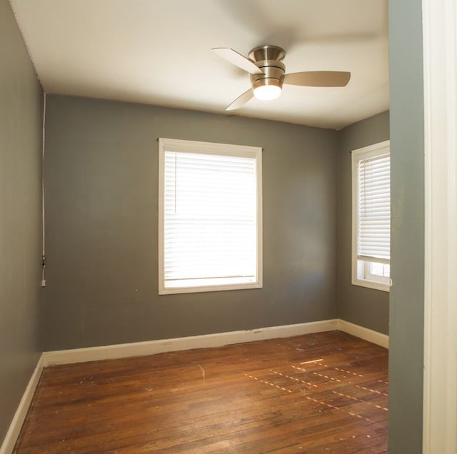 spare room featuring a ceiling fan, baseboards, and hardwood / wood-style flooring