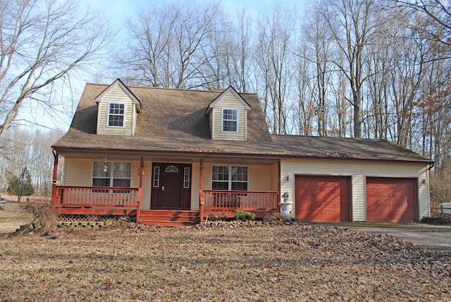 view of front facade with a garage, a porch, driveway, and a shingled roof