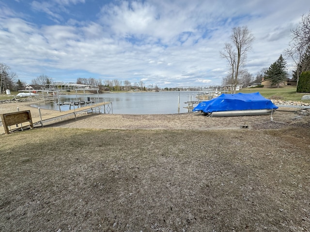 view of dock with boat lift and a water view