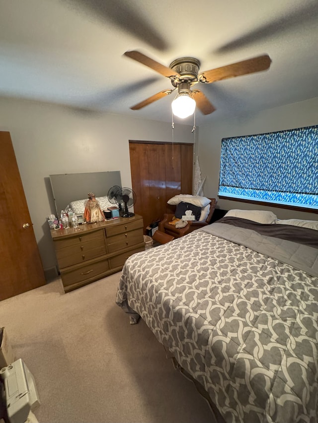 carpeted bedroom featuring a ceiling fan