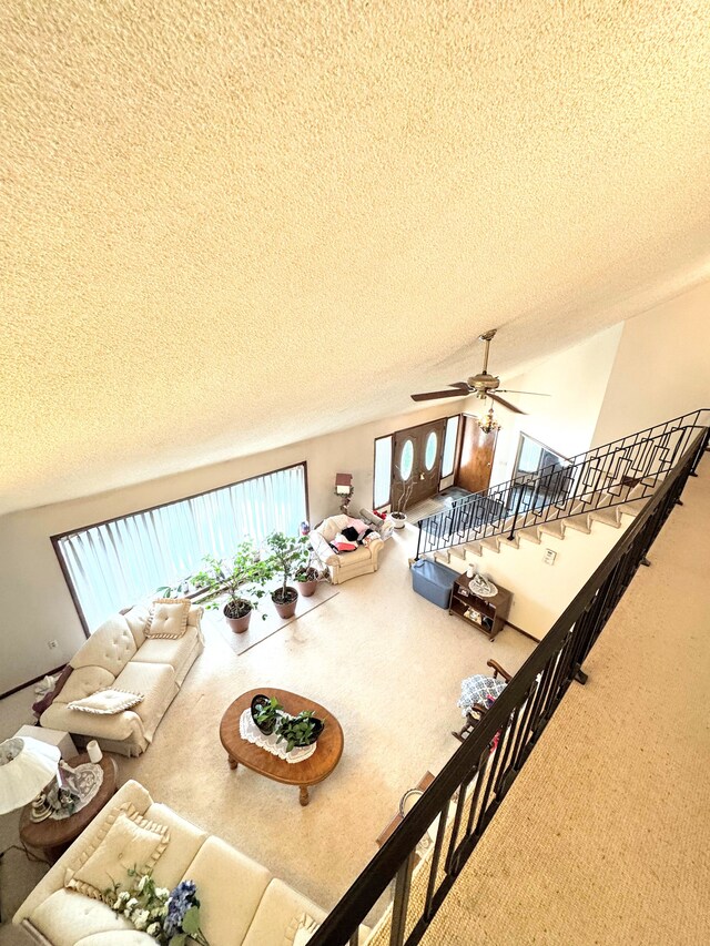 dining room with vaulted ceiling, a ceiling fan, carpet flooring, and a textured ceiling