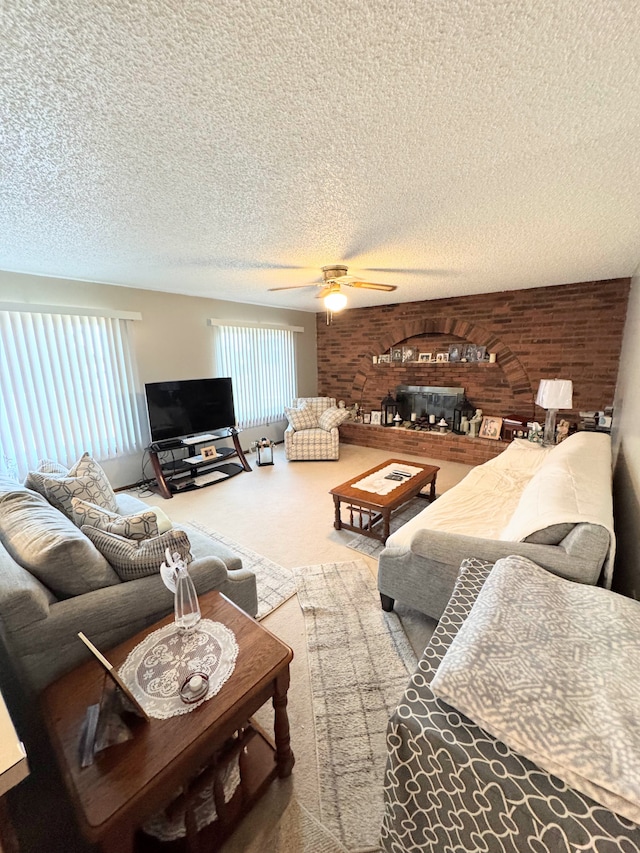 carpeted living room featuring a fireplace, ceiling fan, and a textured ceiling