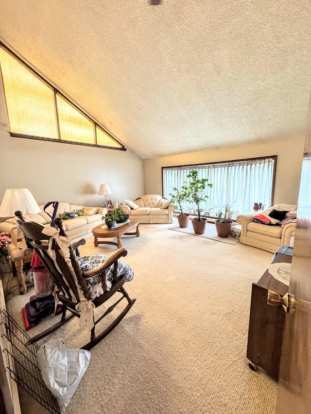 carpeted living room featuring vaulted ceiling and a textured ceiling