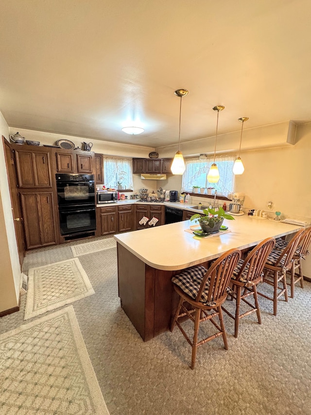 kitchen featuring a kitchen breakfast bar, light countertops, a peninsula, dark brown cabinetry, and black appliances