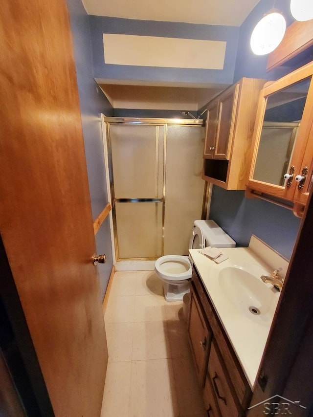 bathroom with tile patterned flooring, a shower stall, toilet, and vanity