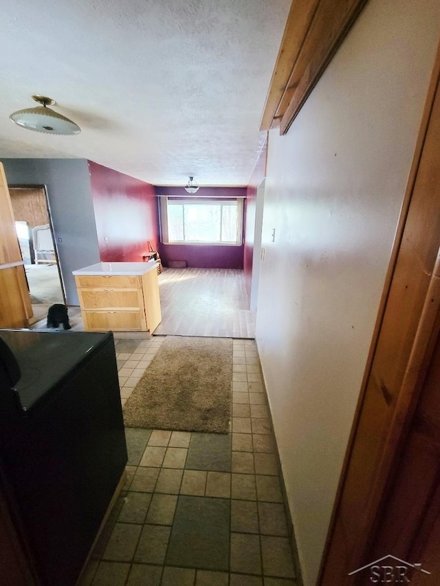 hall with tile patterned floors and baseboards