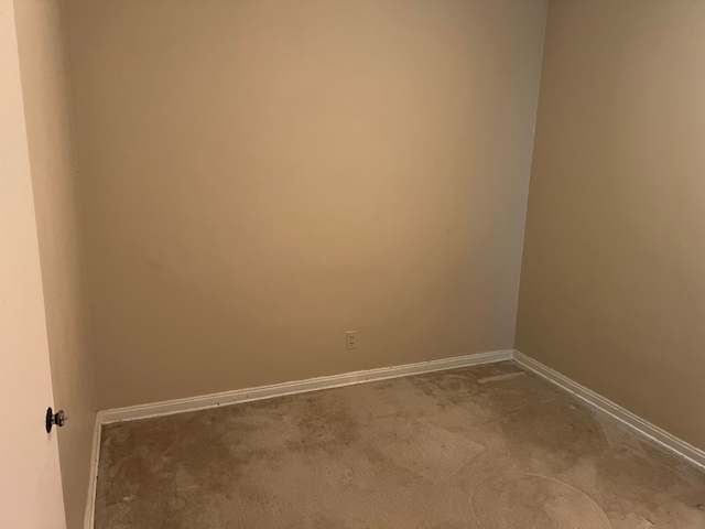 spare room featuring baseboards and carpet floors