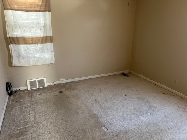 unfurnished room featuring visible vents, baseboards, and carpet floors