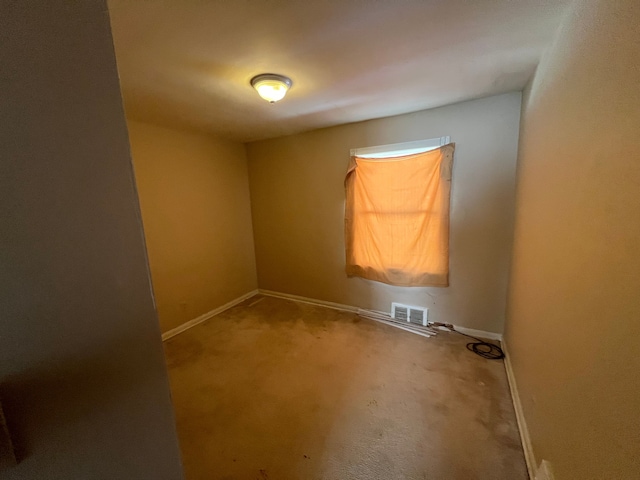 unfurnished room with baseboards, visible vents, and carpet floors