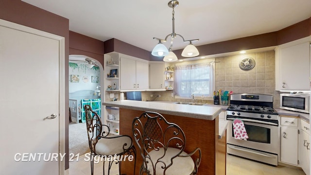 kitchen featuring backsplash, open shelves, white cabinets, stainless steel appliances, and a sink