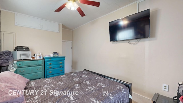 bedroom with a ceiling fan and ornamental molding