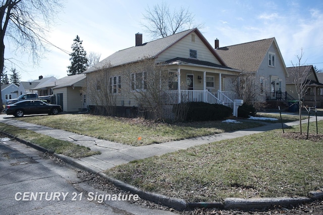 bungalow-style house with a porch, a chimney, and a front lawn